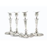 A set of four 19th century Sheffield plate candlesticks, elliptical bases and sconces, 30cm (8)