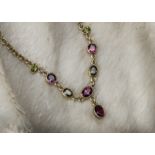 A modern 9ct gold and tourmaline fringe necklace, the lower section with green and pink stones and