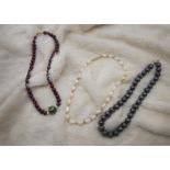 A collection of freshwater pearl necklaces, including one Tahitian black pearl example, other