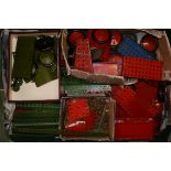 1950s red and green Meccano, various components including plates, strips, clockwork motors, nuts,