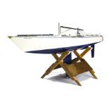 A large Marblehead Radio Controlled Yacht, in white with dark blue keel, with masts, sails and
