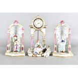 A Naples porcelain clock garniture, clock modelled surmounted upon an arched column base with a