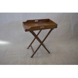 A 19th Century mahogany butler's tray and stand, rectangular, with pierced grips and folding