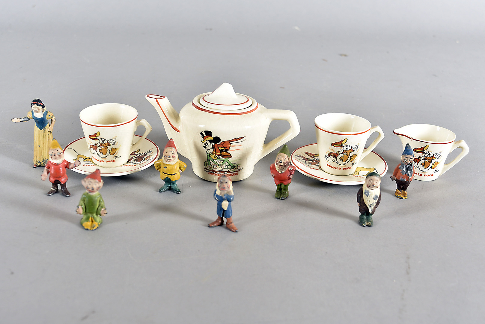 A Wade Heath child's Disney tete a tete, comprising two cups and saucers, teapot and milk jug