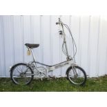 Cycling, a Bickerton folding cycle, finished in silver with matching mud guards.