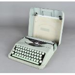 A Hermes Baby typewriter, in two tone green