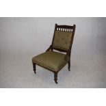 A Victorian oak chair, with carved design to frame, the seat and button back upholstered in green