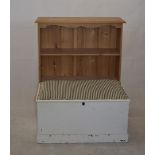 A Victorian painted pine blanket box, with later upholstered lid, and modern pine bookcase (2)
