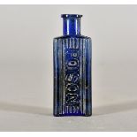 A Victorian blue glass poison bottle, of rectangular form with reeded design beneath the moulded '