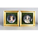 A pair of continental Vienna plaques, depicting young girls in fashionable dress, 14 cm diameter,