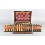 An Edwardian games compendium, in rosewood, with steeple chase game, chess pieces, fold out