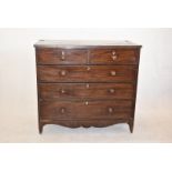 A George III chest of drawers, two short over three graduated drawers, having inlaid lock surrounds,
