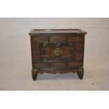 A Korean brass-bound wooden table top cabinet, fitted with drawers and cupboard, 53cm high x 58cm