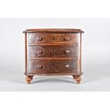 A 19th Century miniature mahogany bow fronted chest of drawers, three graduated drawers on turned,