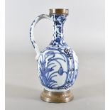 An 18th Century Japanese blue and white wine ewer, having floral pattern to body and loop handle