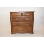 A mahogany chest of drawers, having two short over three long, brass handles, shaped lower frieze on