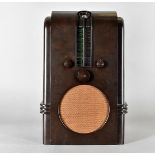 An art deco bakelite Ekco A.C 97. radio, of architectural design with central circular speaker,