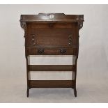 An Arts and Crafts oak bureau, having galleried top, with fold down writing shelf, above single