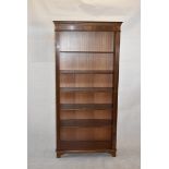 A Georgian-style open mahogany bookcase, with dentil frieze, above adjustable shelves on bracket