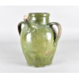 A 19th Century German stoneware twin handled wine ewer, of ovoid form, with all over green glaze, 33