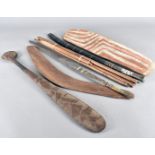 A collection of Aboriginal carved wooden hunting and ceremonial items, including a painted spear and
