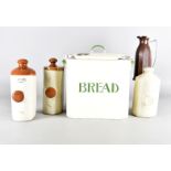 An Art Deco bread bin, with cream ground and green writing, together with a brown Bakelite flask,