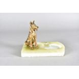 An art deco cold painted bronze and onyx figure group, modelled as a seated German Shepherd, on onyx