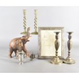 A collection of miscellaneous items, including two pairs of brass candlesticks, a figural example,