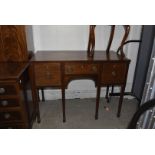 An Edwardian mahogany buffet sideboard, single frieze drawer flanked by two panelled cupboards,