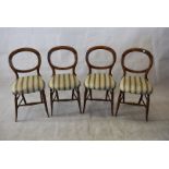 A set of four late Victorian cottage dining chairs, balloon backs, upholstered seats, splayed