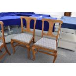 A set of four splat back dining chairs, having newly upholstered seats, in blue fabric with spirals,