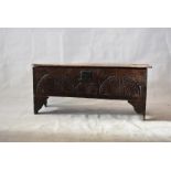 An early 18th Century five-plank elm sword chest, with lift top, carved front and initials 'W D',