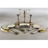 A pair of telescopic silver plated candlesticks, a part silver dressing table set, a string of