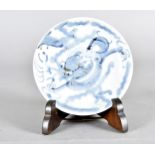 A Chinese Ming Dynasty footed dish, the blue and white dragon design, signed to base, on later