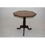 A 19th Century mahogany games table, the octagonal top, having inlaid games board, on turned support