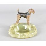 An art deco cold painted bronze and onyx figure group, modelled as a standing Airedale on a textured
