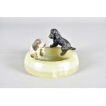 An art deco cold painted bronze and onyx figure group, modelled as two spaniel puppies playing