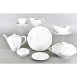An extensive KPM porcelain dinner and tea service, having white ground with multi-coloured leaf