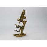 A late 19th Century Ross Eclipse lacquered brass Compound Monocular Microscope, German pattern, with