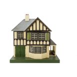 A Tri-ang Wooden half-timbered Dolls' House, painted cream, tinplate windows, front door to side