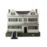 A large Tri-ang Wooden Dolls' House, painted cream with tinplate windows and green cardboard