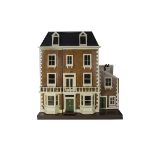 A large painted Wooden Dolls' House probably G & J Lines, of three stories, central front door