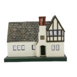 A Tri-ang No1 Mayflower Doll's House 1928, rough-cast façade with half-timbered gable, chimney