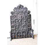 A cast iron 19th Century fire back, with figural design, together with a guard and front