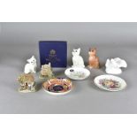 Two Beswick porcelain cat figures, together with a similar Royal Doulton example, plus a Royal