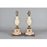 A pair of alabaster and marble table lamps, having square marble bases, with mounted metal feet