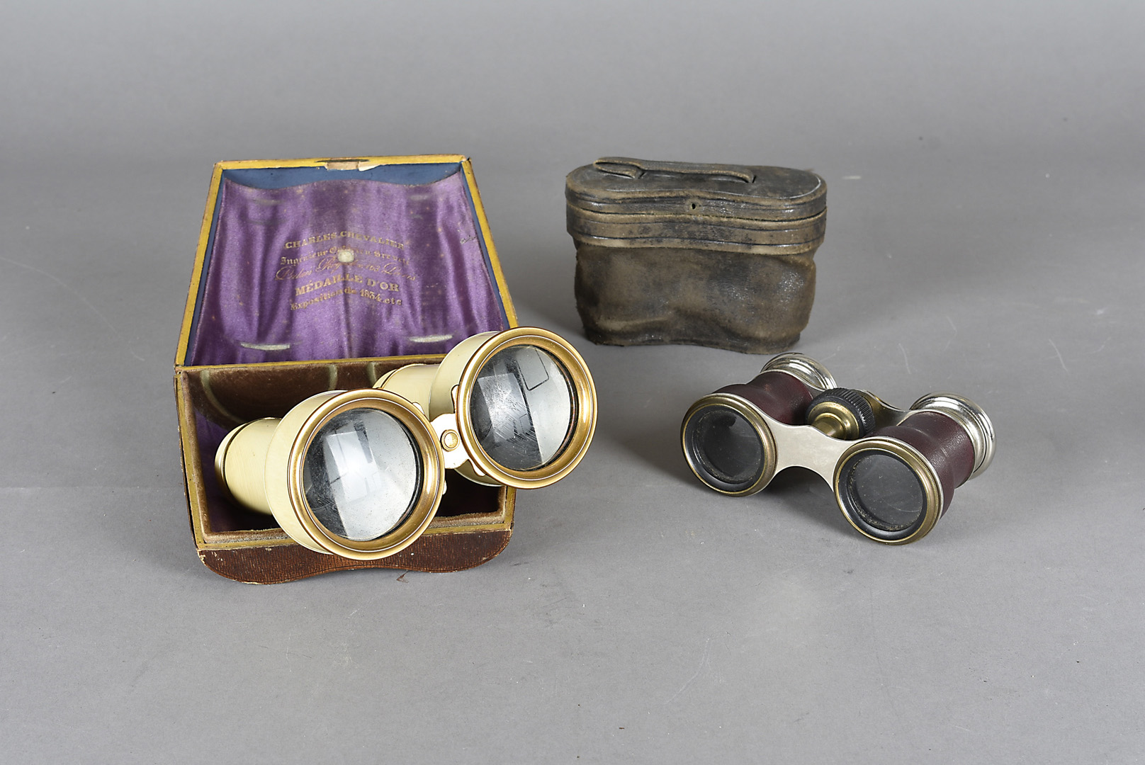 A cased pair of 19th century French ivory field and opera glasses by Charles Chevalier, in fitted