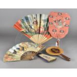 An interesting fixed paddle theatre souvenir fan, the wooded leaf painted with portrait of a