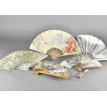 Seven early 20th century folding champagne Advertising fans, paper leaf and wooden sticks,