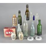 A collection of glass and stoneware bottles, together with a blue optrex eye bath, two tins, pottery